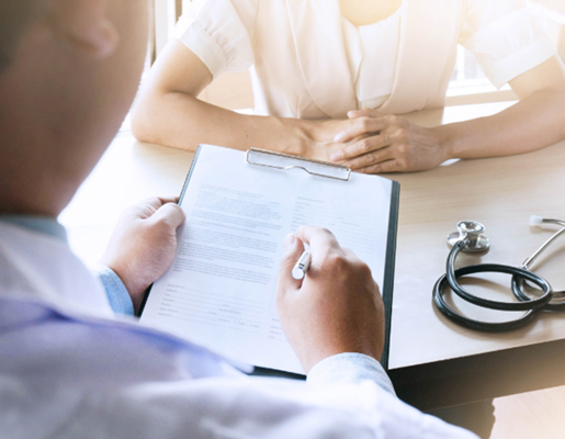 Doctor consulting a patient with a clipboard