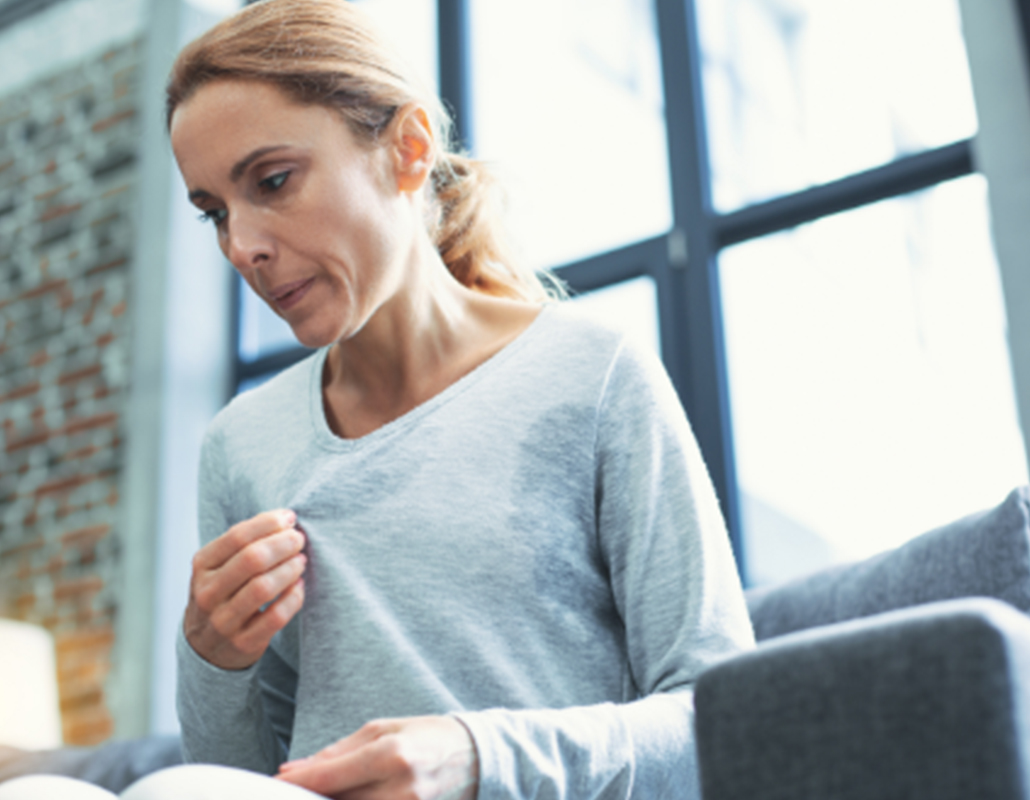 Middle-aged woman experiencing hot flashes from menopause