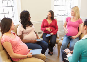 Pregnant women sitting in a group prenatal class